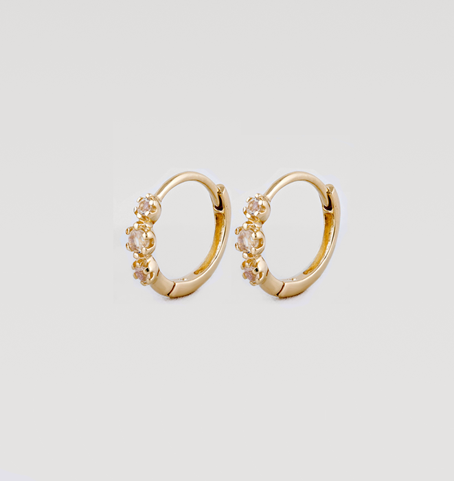 Small hinged solid gold earrings set with three moonstone stones
