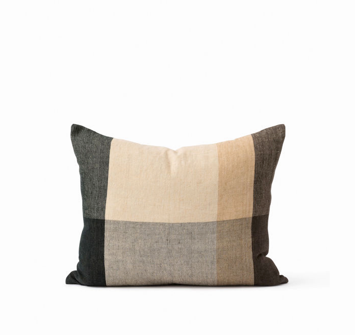 Checkered pillow with brown, beige, and black colors on a white background