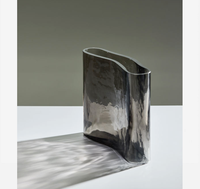 Vase on a white surface with a gray background