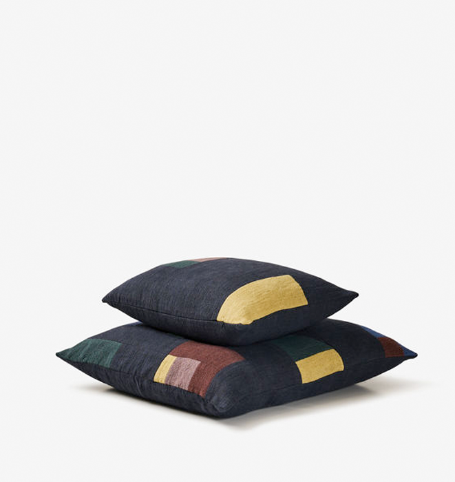 Two decorative pillows with geometric patterns on a white background