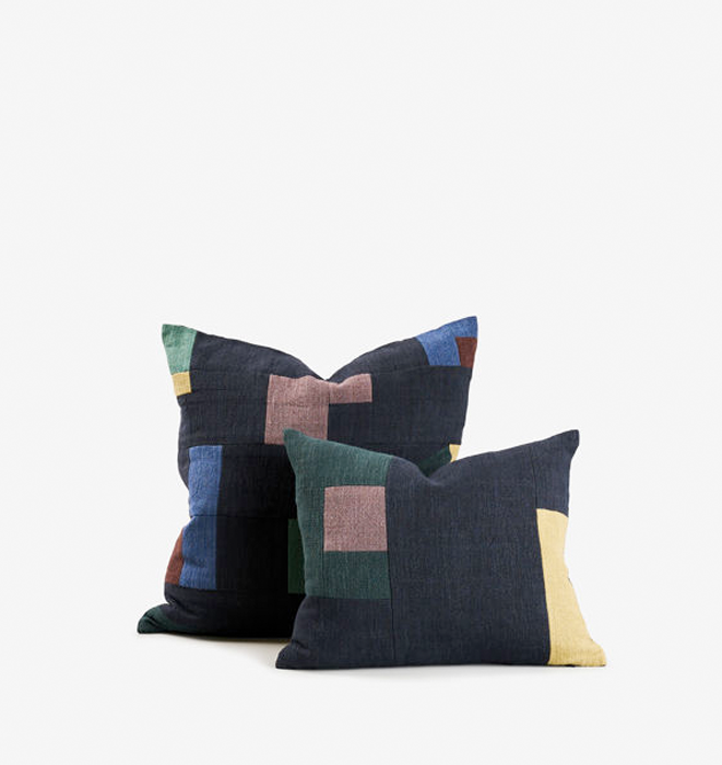 Two geometric-patterned pillows on a white background