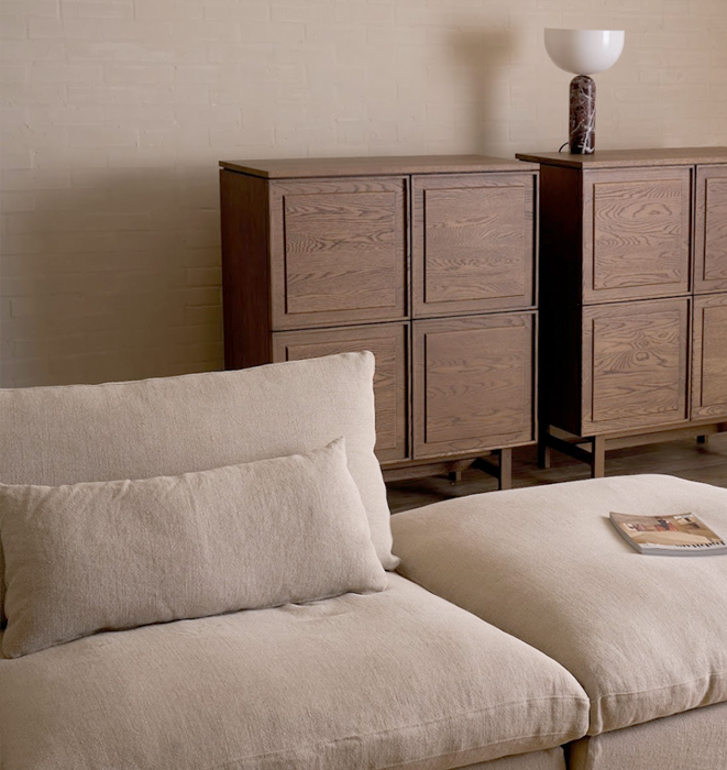 Beige sofa with wooden cabinet in a room setting
