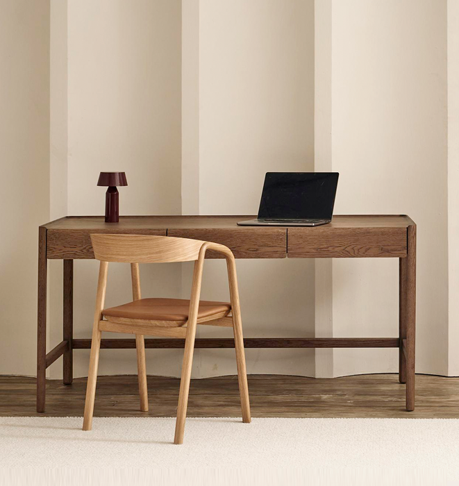 Wooden desk with a chair and a laptop on a neutral background