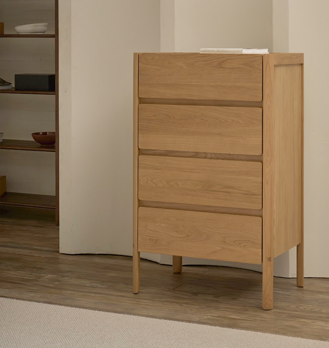 Wooden dresser with four drawers in a room setting