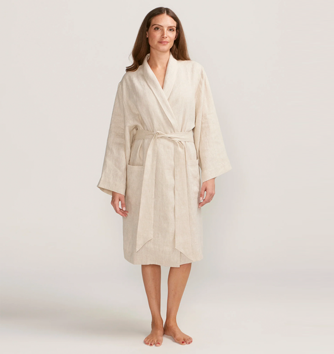 Woman wearing a beige robe on a white background