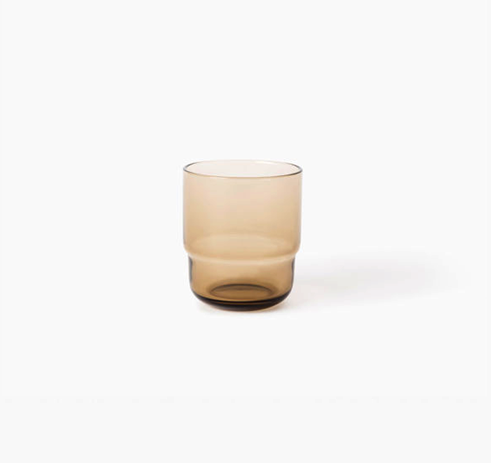 Glass tumbler with a gradient color from beige to brown on a white background