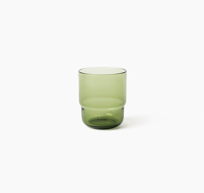 Green glass tumbler on a white background