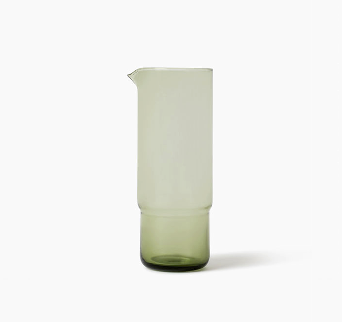 Green glass pitcher on a white background