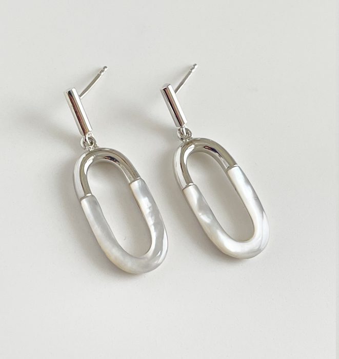 A modern oval and bar drop earring set with Mother of Pearl inlay.  Made in sterling silver with a 14k gold vermeil. Packaged in a Kartique silk/cotton draw string pouch.